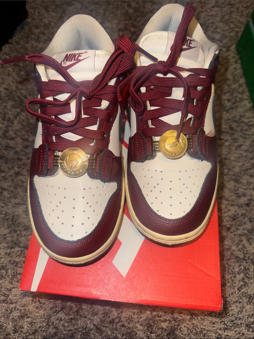 Nike Kids White and Burgundy Low-Top Sneakers with Gold Medallion